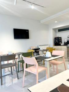 a dining room with tables and chairs and a flat screen tv at Pantarei Palace in Lettere