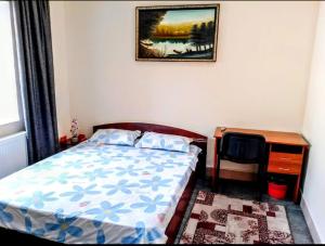 a small bedroom with a bed and a desk at Tima Hotel Chisinau in Chişinău +7 photos