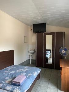 a bedroom with a bed and a tv on the ceiling at Tima Hotel Chisinau in Chişinău