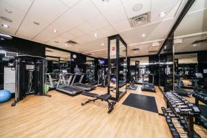 a gym with several treadmills and elliptical machines at PlanURstay - Ideal 2BR & 2 BTH - Near SQ1 Mall in Mississauga