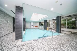 a large swimming pool in the middle of a building at PlanURstay - Ideal 2BR & 2 BTH - Near SQ1 Mall in Mississauga