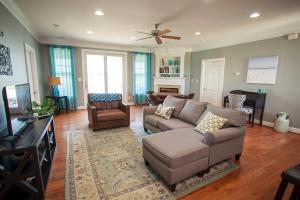 a living room with a couch and a tv at The Inn, Occano Arnold Palmer Golf, Luxury 4 Bedroom 