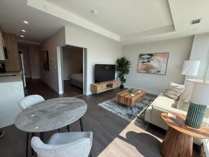a living room with a table and a couch at Downtown Bright & Vibrant 1 BR with huge patio in Halifax