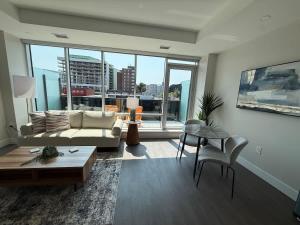a living room with a couch and a table at Downtown Bright & Vibrant 1 BR with huge patio in Halifax