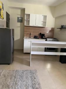 a kitchen with a white counter and a refrigerator at Sole 1  +2 photos