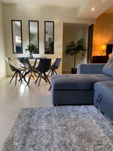 a living room with a couch and a table and chairs at Sole 1 