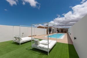 ein Haus mit Pool und grünem Gras in der Unterkunft Esencia House Bajo las Estrellas in Llanos de la Concepción