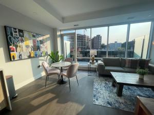 a living room with a couch and a table at Downtown bright and modern 1 BR with 6 appliances in Halifax