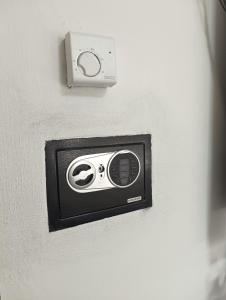 a electrical outlet on a wall with a controller at Da Mario in Auronzo di Cadore