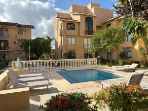 a building with a swimming pool in front of a building at Cancun Condo & Resort in Cancún
