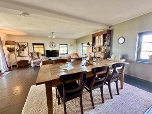 a dining room with a large wooden table and chairs at Petit Wilogne in Dinez