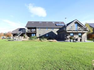 a large house with a large yard in front of it at Petit Wilogne in Dinez