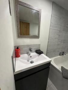 a bathroom with a sink and a mirror and a tub at Tranquil detached barn in Sherborne St John in Sherborne Saint John +7 photos