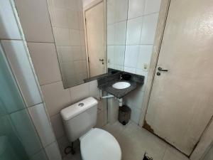 a small bathroom with a toilet and a sink at Ap Cop 30 in Belém +16 photos