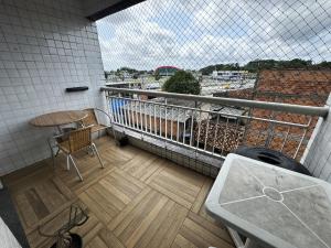 a balcony with a table and chairs on a balcony at Ap Cop 30 in Belém