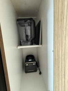 a blender and a blender sitting on a shelf at Penthouse downtown 1 Bedroom with 6 appliances in Halifax