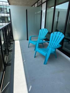 two blue chairs sitting on the side of a building at Penthouse downtown 1 Bedroom with 6 appliances in Halifax
