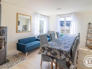 a dining room with a blue table and chairs at Gîte familial pour 8 pers. à Saint Aubin de Luigné - FR-1-622-117 in Saint-Aubin-de-Luigné