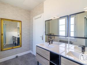 a bathroom with a sink and a mirror at Gîte familial pour 8 pers. à Saint Aubin de Luigné - FR-1-622-117 in Saint-Aubin-de-Luigné +12 photos