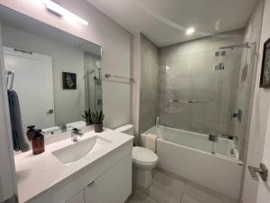 a bathroom with a sink and a toilet and a shower at Waterfront downtown 1 Bedroom with 6 appliances in Halifax