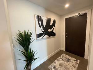 a hallway with a black door and a plant at Waterfront downtown 1 Bedroom with 6 appliances in Halifax +2 photos