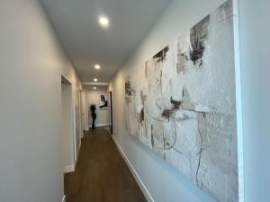 a hallway of a house with art on the walls at Waterfront downtown 1 Bedroom with 6 appliances in Halifax