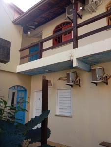 a building with two balconies on the side of it at Pico das Praias Suites in Itacaré