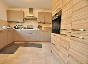 a kitchen with white cabinets and a stove top oven at Seaside-Retreat in Largs