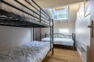 a bedroom with two bunk beds and a window at Harria in Bidache +37 photos