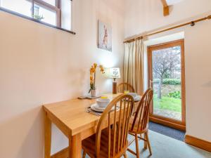 a dining room with a wooden table and chairs at The Cottage - Uk45459 in Loftus