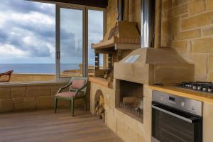 a kitchen with a stove with a view of the ocean at Elafonisi Villa above the Beach in Elafonisi