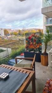 a patio with a table and flowers on a balcony at Escape The Ordinary in Bucharest +15 photos