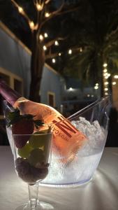 a drink in a wine glass on a table at Hotel Maculís in Campeche