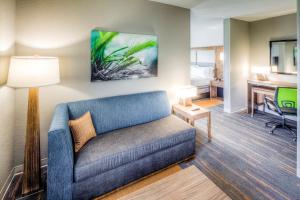 a living room with a couch and a desk at Holiday Inn Express & Suites Cleveland/Westlake, an IHG Hotel in Westlake