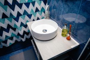 a bathroom with a white sink on a counter at Mony Apartaments in Roman