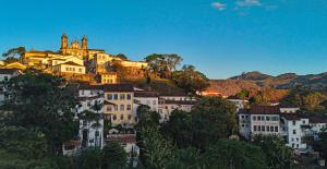 a town with a castle on top of a hill at Varanda Pouso e Arte in Ouro Preto