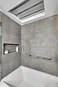 a bathroom with a large white tub in a room at Luxurious Three-Bedroom Oceanfront Apartment with Private Balcony in Hollywood Beach