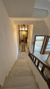 un escalier dans une maison avec couloir dans l'établissement Villa Pietra Sardinia - Luxury 165 m2 Historic Stone House with Fireplace and Rooftop, à Tempio Pausania 28 autres photos