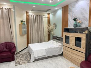 a room with a bed and a tv and a chair at TWO M RÉSIDENCE M&M Thies ZAC Nguinth in Thiès