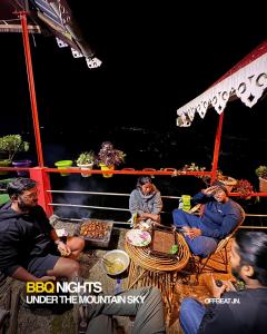 a group of men sitting around a table on a boat at Offbeat Jn in Sukhia Pokhari