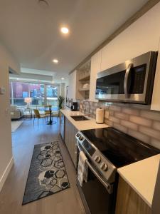 a kitchen with a stove and a counter top at Downtown bright & cozy 1 BR with 6 appliances in Halifax