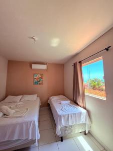 Postel nebo postele na pokoji v ubytování Casa Temporada Suítes