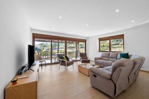 a living room with a couch and a television at Terra Nossa in Vila Real