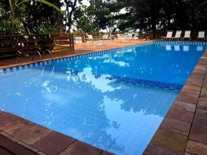 a large swimming pool with blue tiles on it at Paradise at your feet in São Sebastião