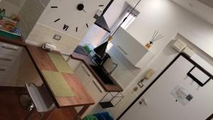 an overhead view of a living room with a clock on the wall at Bilocale in Palazzo del XVI Secolo in Campobasso