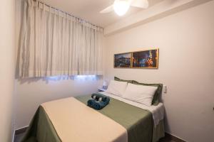 a bedroom with a bed with a camera on it at Apto Novo Centro SP Com Vista Panorâmica in Sao Paulo +92 photos