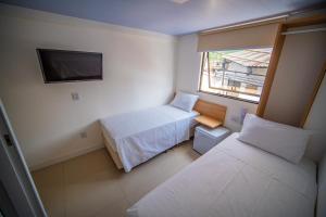 Cama ou camas em um quarto em Amazinn Hotel