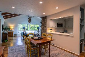 a kitchen and living room with a table and chairs at Elk Watch at Hound Ears in Valle Crucis