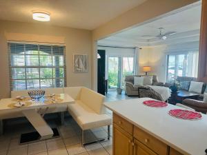 a kitchen and living room with a table and chairs at Siesta Key Beach House in Siesta Key