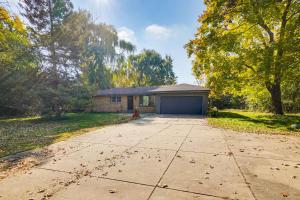 a house with a garage in the middle of a driveway at 2 Mi to Pewaukee Lake! Peaceful Retreat with Yard in Pewaukee